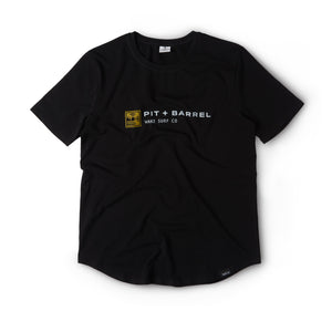 Front View of a Black t-shirt with 'Pit + Barrel' logo with gold barreling wave on a white background