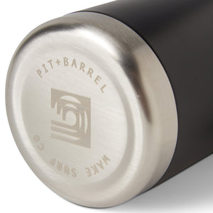 Bottom view of insulated drink holder in black featuring 'Pit + Barrel Wake Surf Co.' text with curling wave logo. 