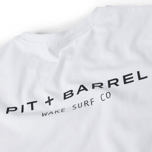 Detail View of a White t-shirt with a logo printed in black graphic that states 'Pit+Barrel' on a white background.