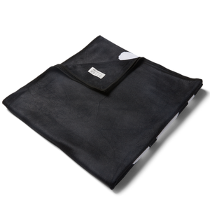 Black Microfiber towel folded up with corner pulled over to show texture and sheen of fabric. 