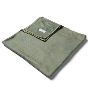 Lake Vibes | Sage Microfiber towel folded up with corner pulled over to show texture and sheen of fabric with simplistic care instructions. 