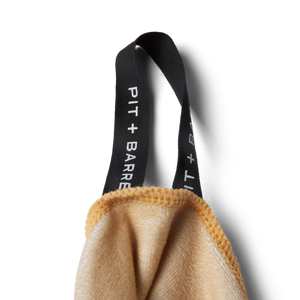 Unsalted & Shark-Free | Tan Detail shot of tag logo for hanging of microfiber towel. 